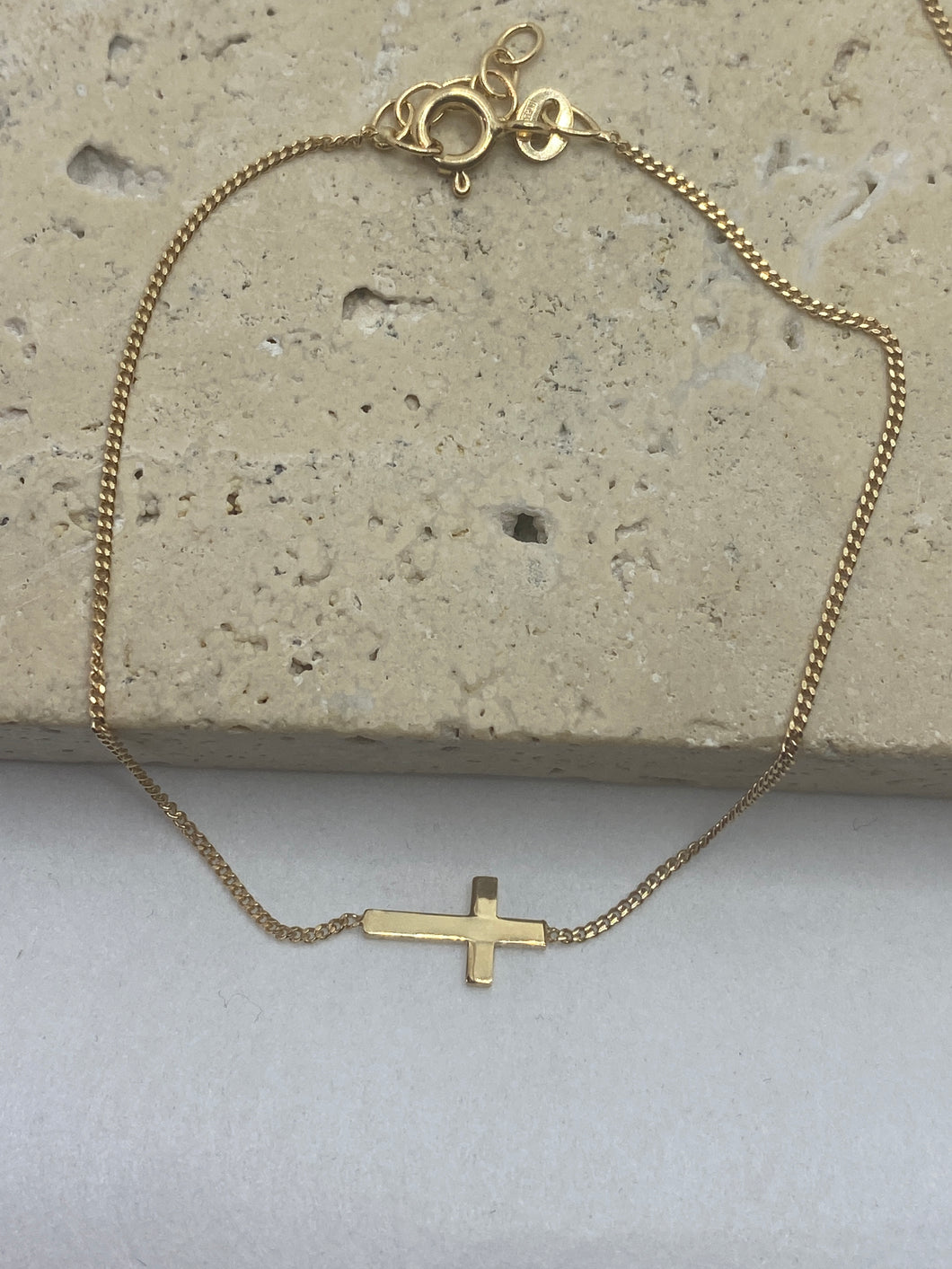 9k Gold resting Cross necklace