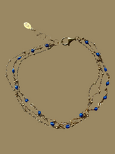 The triple row lapis and gold bracelet.