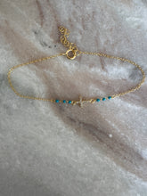 The petite cross with turquoise beads