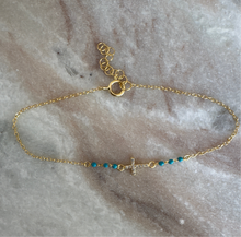 The petite cross with turquoise beads
