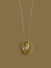 Brushed gold cage with pearl