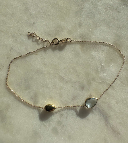 14k solid gold bracelet with blue topaz and gold bead.