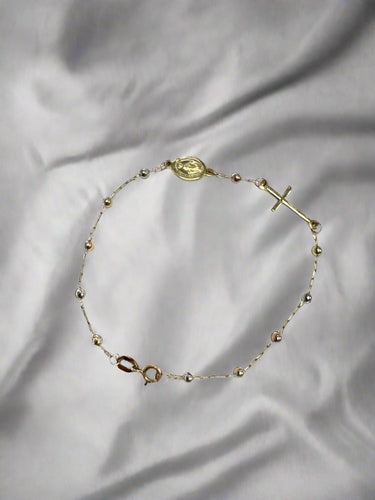 9k gold ball bracelet with cross and medallion.