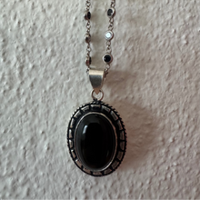 Onyx oval pendant with small cabochon semi precious stones.