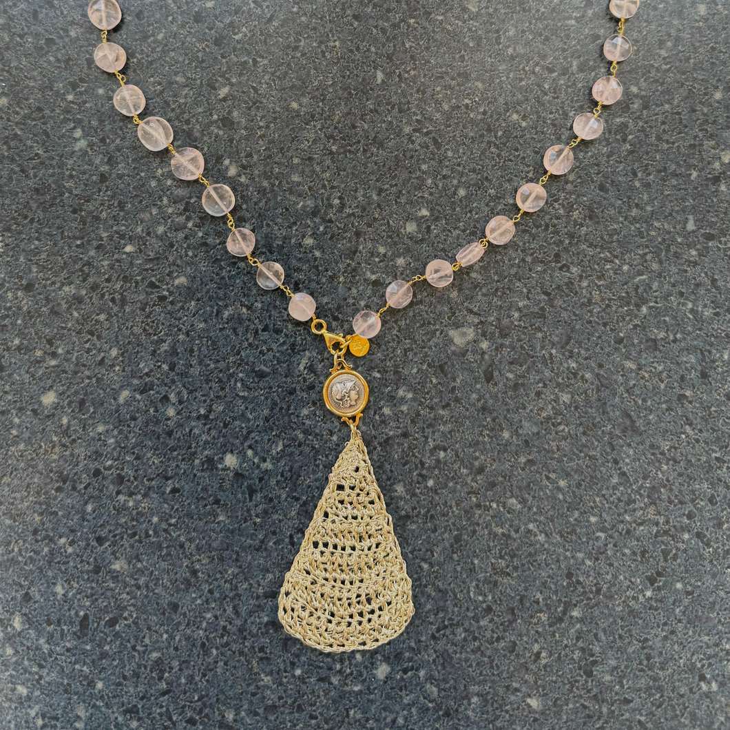 A rose quartz beaded necklace with a gold vermeil over sterling silver chain and a crochet pendant with a coin of goddess Athena.