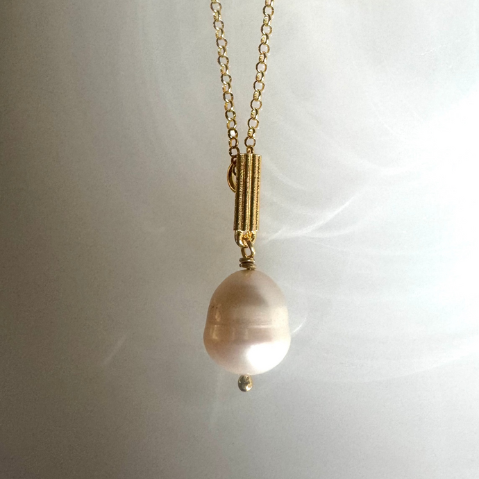 Iconic column with fresh water pearl necklace.