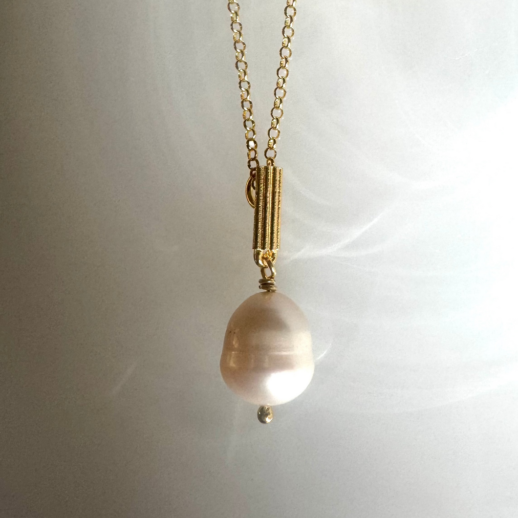 Iconic column with fresh water pearl necklace.