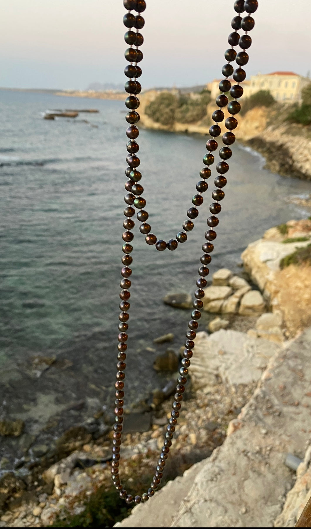 Long peacock pearl necklace.