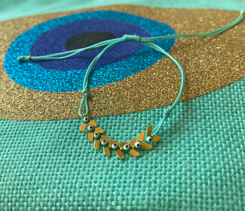 The turquoise cord bracelet with 8 tiny eyes and gold 🍃
