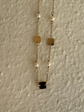 Golden squares and Akoya pearl necklace