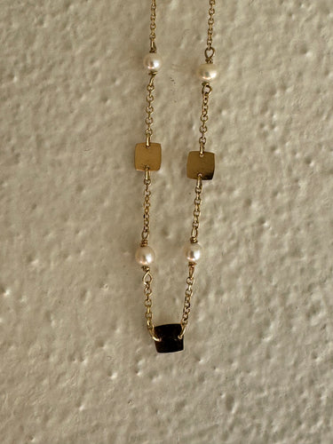 Golden squares and Akoya pearl necklace