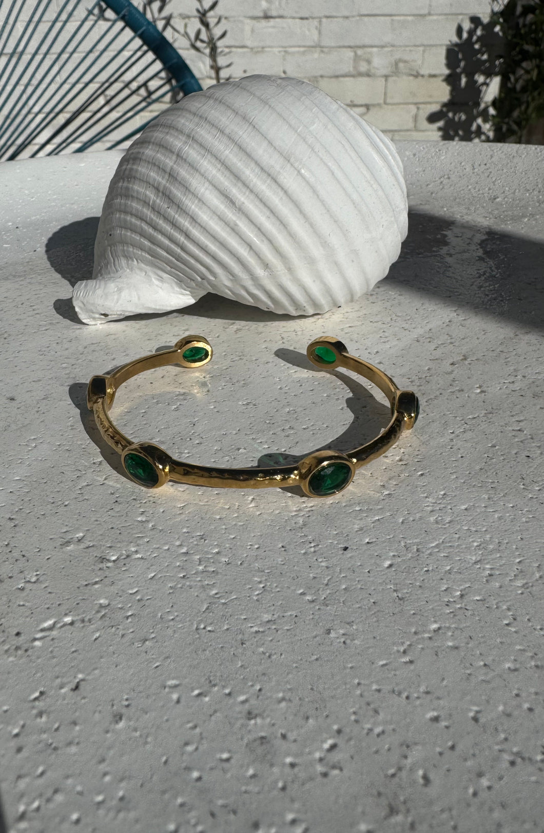 Hammered open bangle with green cubic zircons