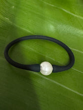The Mono lustrous fresh water pearl on black silicon.
