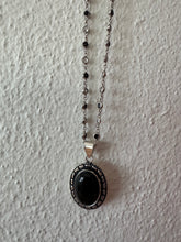 Onyx oval pendant with small cabochon semi precious stones.