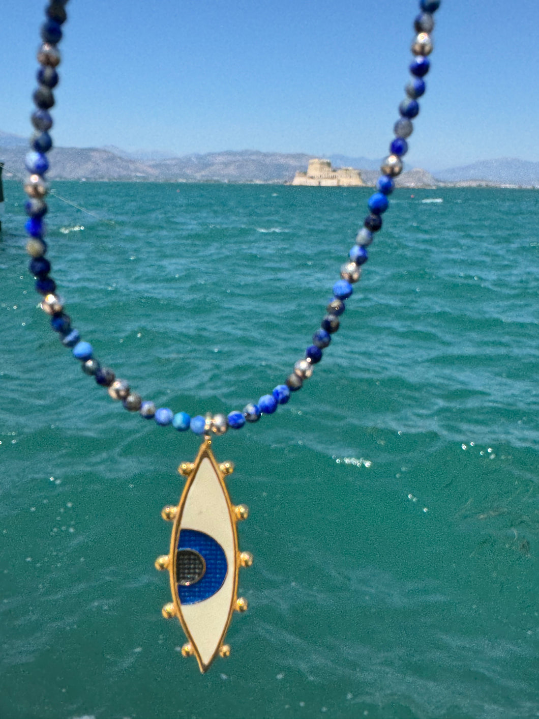 Nafplio enamel eye on lapis lazuli beads.