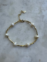 The 6 fresh water pearls with gold beads