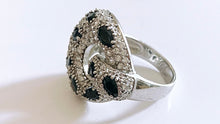 Cocktail ring with black faceted onyx eyelets and white CZ