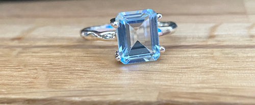 Blue topaz emerald cut four claw silver ring
