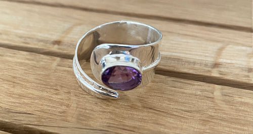 Amethyst oval cut on wide silver leaf open band