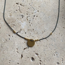 The dainty green and gold circle necklace