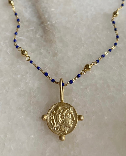 Alexander the Great coin on blue lapis beads.