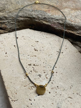 The dainty green and gold circle necklace