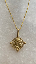 Alexander the Great coin on blue lapis beads.