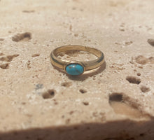 The curved turquoise ring